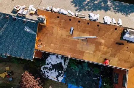 Homeowner reviewing roof insurance claim documents in Louisiana