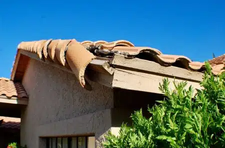 Storm damage to residential roof in New Orleans showing potential leak points