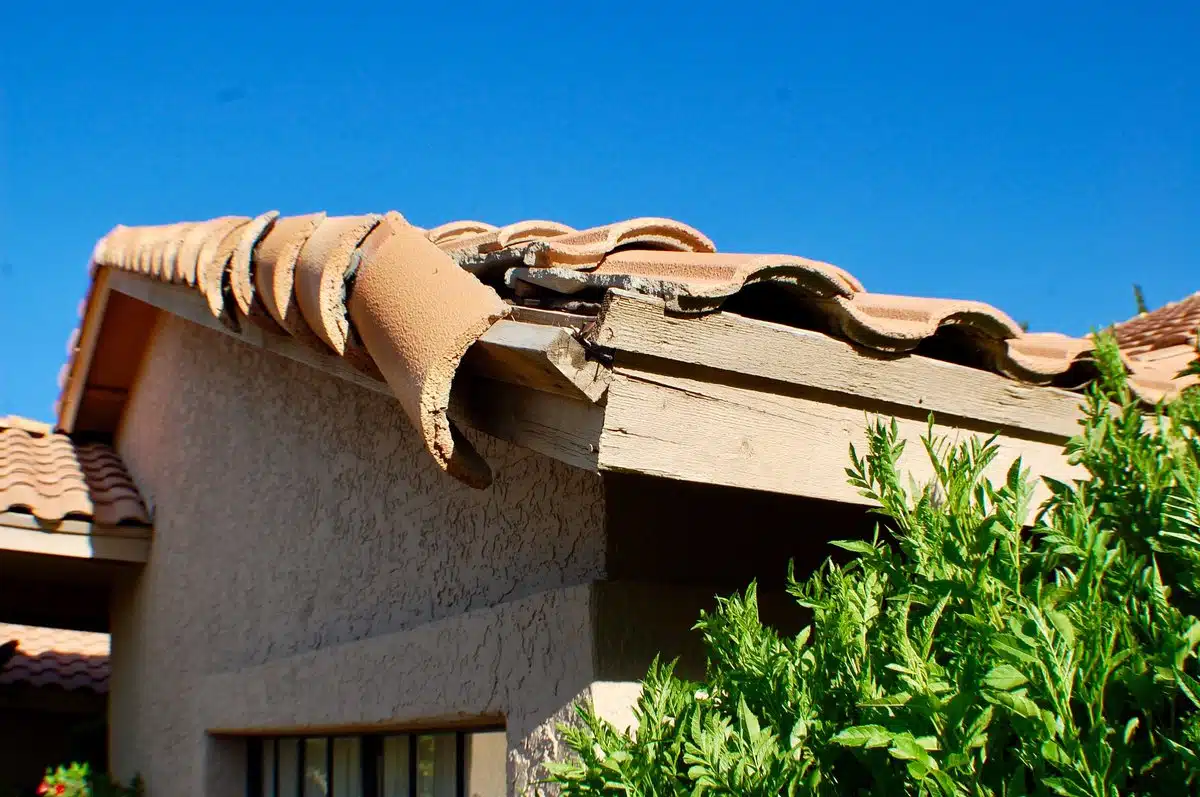 Storm damage to residential roof in New Orleans showing potential leak points