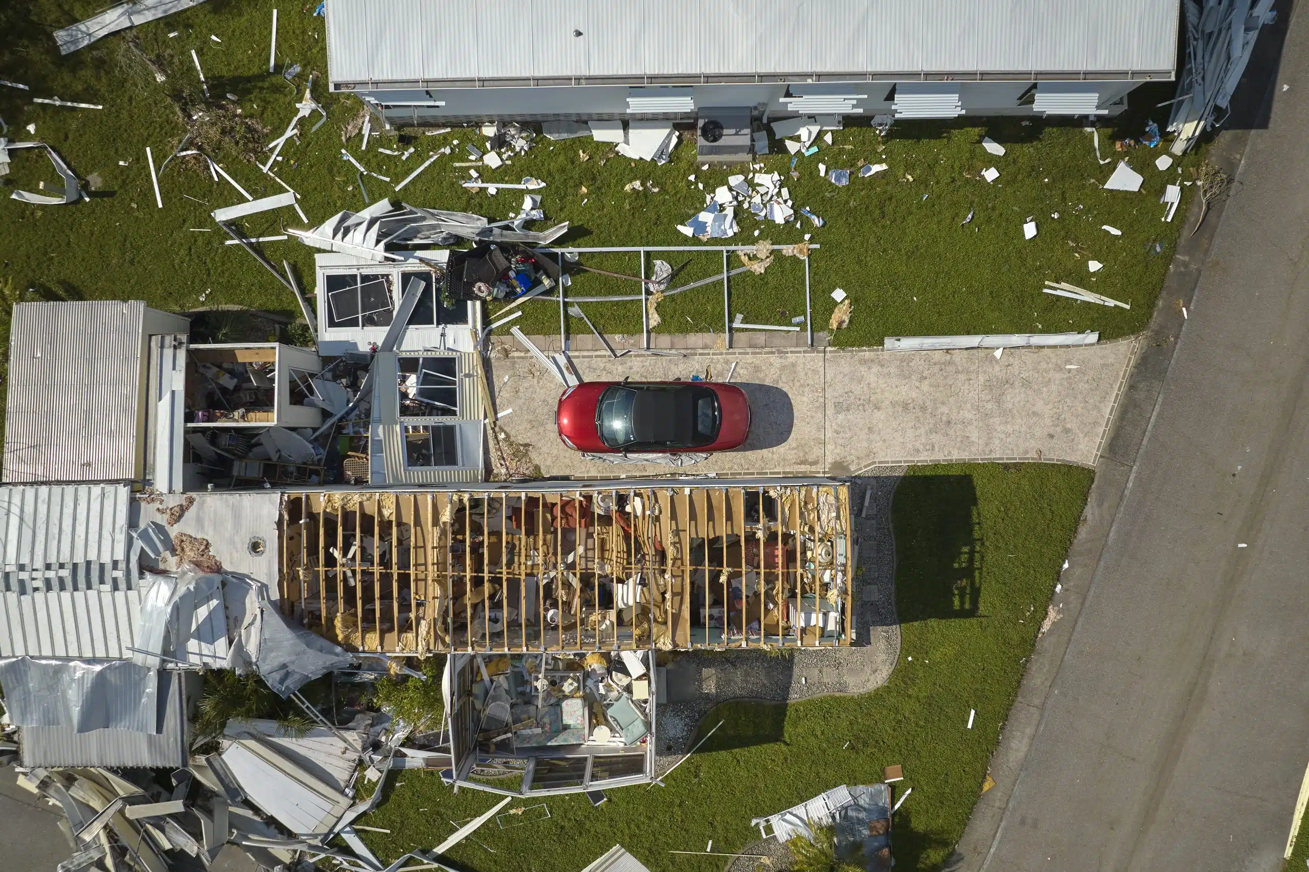 Hurricane aftermath aerial view of New Orleans neighborhood with widespread roof damage