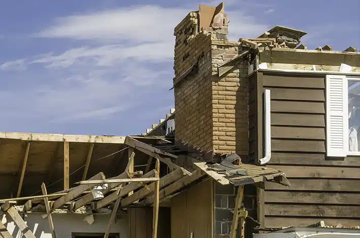 New Orleans home with storm-damaged roof awaiting repair by Big Easy Roofing after hurricane