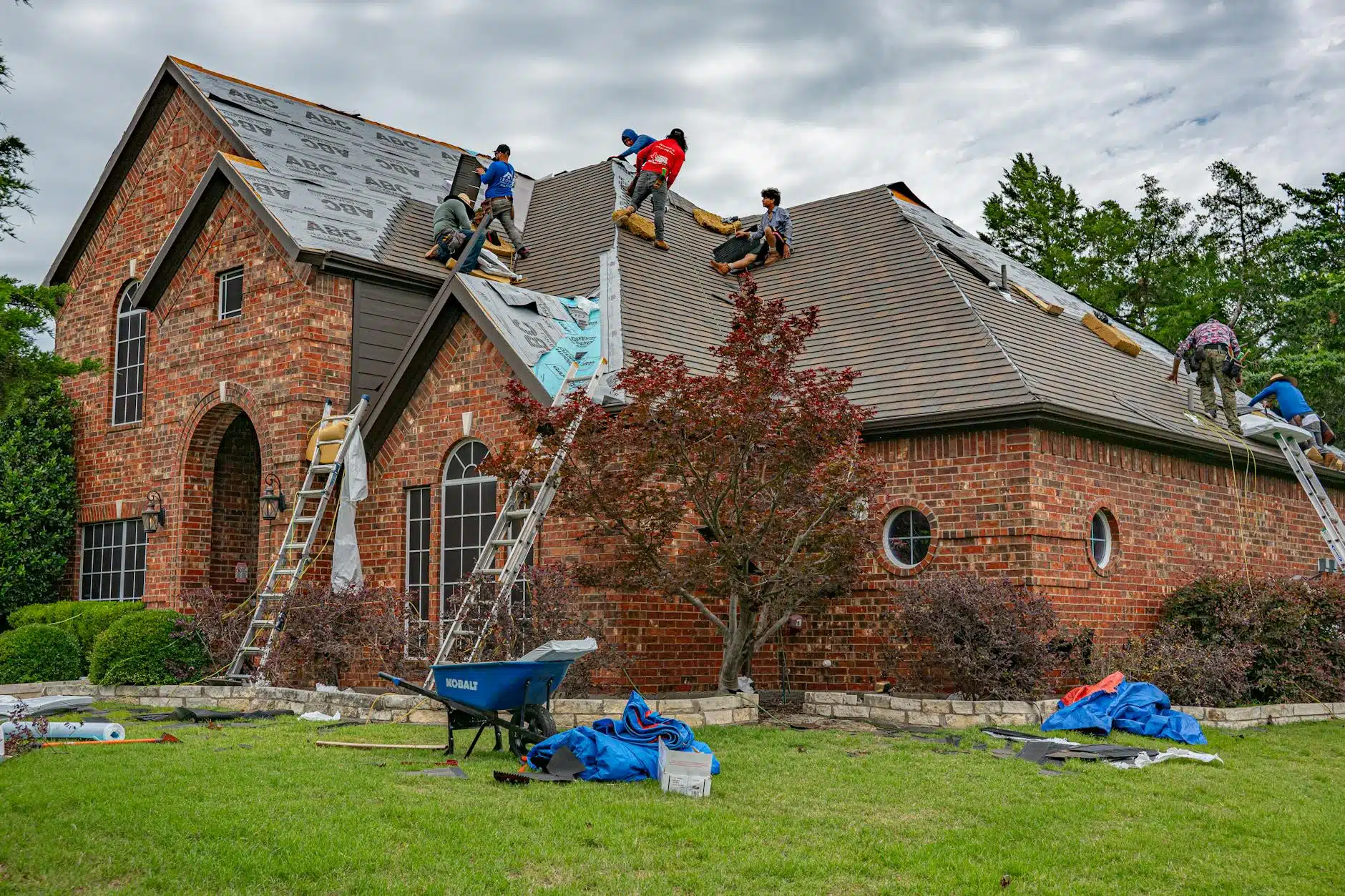 roofers installing shingles on residential home